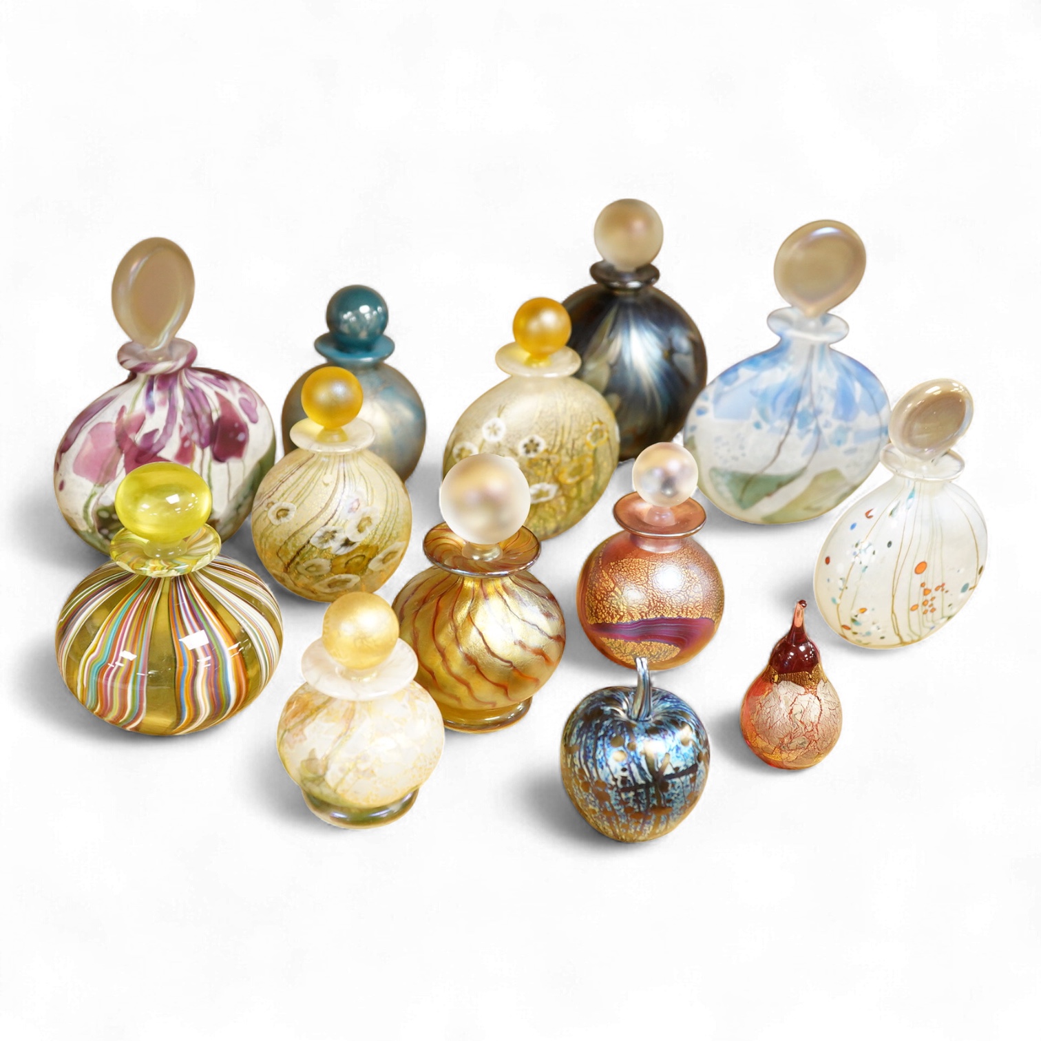 Eleven Isle of Wight studio glass scent bottles and stoppers and a similar apple and pear shaped studio paperweight, tallest scent bottle 13cm high